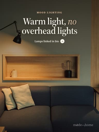 A living room with a couch and a lamp