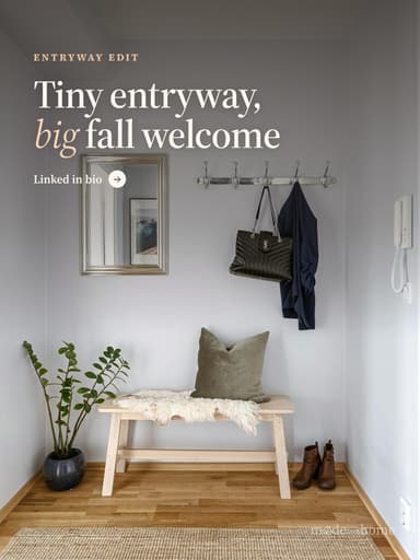 A room with a bench, mirror, coat rack a