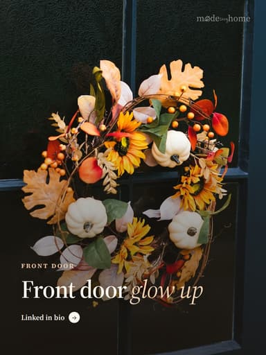 A wreath is hanging on a window sill