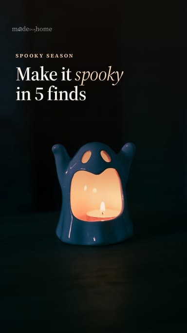 A ghost-shaped lantern with a lit candle