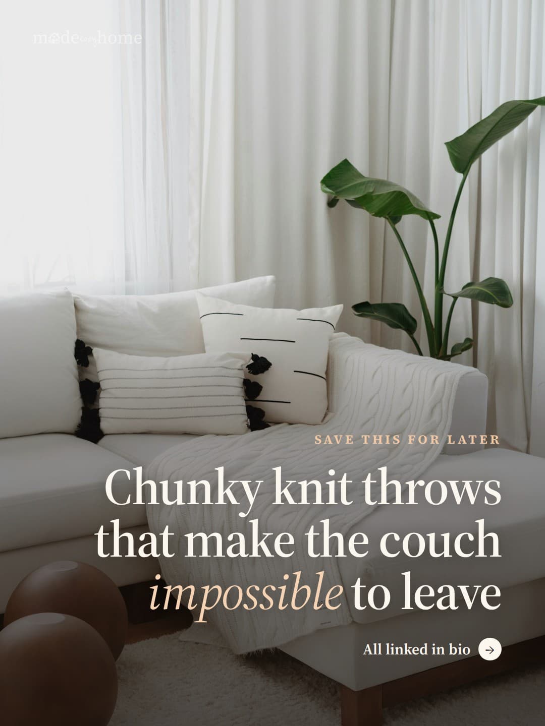 a living room with a white couch and pil