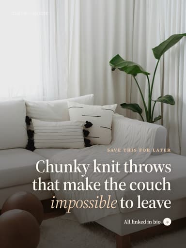 a living room with a white couch and pil